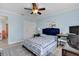 Bedroom with queen bed, workspace, and ceiling fan at 5011 Winwood Way, Orlando, FL 32819