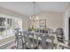 Bright dining room featuring a large table, chandelier, and hardwood floors at 5011 Winwood Way, Orlando, FL 32819