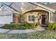 Front entrance with brick walkway and landscaping at 5011 Winwood Way, Orlando, FL 32819