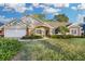 Beautiful two-story home with landscaped lawn and attached two-car garage at 5011 Winwood Way, Orlando, FL 32819