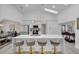 Modern kitchen with white cabinetry, quartz countertops, and a large island at 5011 Winwood Way, Orlando, FL 32819