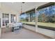 Lovely screened porch with a floral table setting and backyard view at 5011 Winwood Way, Orlando, FL 32819
