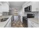 Bright kitchen featuring granite countertops and white cabinets at 5144 Orange Ave, Winter Park, FL 32792