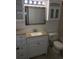 Well-lit bathroom with a new vanity, toilet, and flooring at 5291 Images Cir # 204, Kissimmee, FL 34746