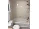 Clean bathroom featuring a shower/tub combo and updated flooring at 5291 Images Cir # 204, Kissimmee, FL 34746
