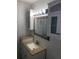 Bright bathroom with granite countertop, updated vanity, and mirrored medicine cabinet at 5291 Images Cir # 204, Kissimmee, FL 34746
