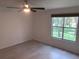 Bright bedroom with wood-look floors and a large window at 5291 Images Cir # 204, Kissimmee, FL 34746