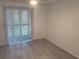 Bedroom with wood-look floors and sliding glass door at 5291 Images Cir # 204, Kissimmee, FL 34746