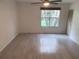 Bright bedroom with wood-look floors and window at 5291 Images Cir # 204, Kissimmee, FL 34746
