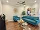 Living room with hardwood floors, teal sofas, and a modern coffee table at 9235 Sweet Maple Ave, Orlando, FL 32832