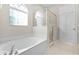 Bathroom featuring a bathtub, shower, and window at 1108 Darnaby Way, Orlando, FL 32824