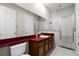 Bathroom features a shower and red countertop vanity at 1108 Darnaby Way, Orlando, FL 32824