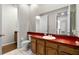 Bathroom with wood cabinets and red countertop at 1108 Darnaby Way, Orlando, FL 32824