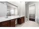 Bathroom with double vanity, large mirror, and walk-in shower at 1108 Darnaby Way, Orlando, FL 32824