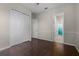 Comfortable bedroom featuring closet, adjoining bathroom, and dark wood flooring at 1108 Darnaby Way, Orlando, FL 32824