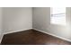 This bedroom boasts hardwood floors, neutral colors, and a bright window at 1108 Darnaby Way, Orlando, FL 32824
