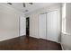 Bedroom with double door closet and dark brown laminate flooring at 1108 Darnaby Way, Orlando, FL 32824