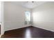 Cozy bedroom featuring hardwood floors and a window with natural light at 1108 Darnaby Way, Orlando, FL 32824