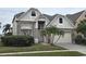 Two-story house with stone accents and a three-car garage at 1108 Darnaby Way, Orlando, FL 32824