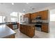 Updated kitchen with island, stainless steel appliances, and wood cabinets at 1108 Darnaby Way, Orlando, FL 32824