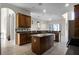 Spacious kitchen featuring wood cabinetry, an island, and stainless steel appliances at 1108 Darnaby Way, Orlando, FL 32824