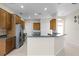 Spacious kitchen with wooden cabinetry, a breakfast bar, and stainless steel appliances at 1108 Darnaby Way, Orlando, FL 32824