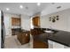 Spacious kitchen features wood cabinetry, an island, breakfast bar, and tile floors at 1108 Darnaby Way, Orlando, FL 32824