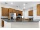 Spacious kitchen featuring wood cabinetry, a breakfast bar, and stainless steel appliances at 1108 Darnaby Way, Orlando, FL 32824