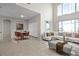 Bright living room features tile floors, high ceilings, large windows, and modern furniture at 1108 Darnaby Way, Orlando, FL 32824