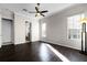 Spacious main bedroom with dark wood floors, ceiling fan, and ensuite bathroom entrance at 1108 Darnaby Way, Orlando, FL 32824