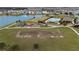 Community overview featuring lake, playground, pool, and open green spaces at 1213 Red Hill Rd, Davenport, FL 33837