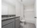 Bathroom with granite countertop, gray cabinets, and a bathtub at 1213 Red Hill Rd, Davenport, FL 33837