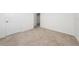 Spacious bedroom with neutral carpeting and a door at 1213 Red Hill Rd, Davenport, FL 33837