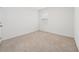 Simple carpeted bedroom with a window and neutral walls at 1213 Red Hill Rd, Davenport, FL 33837