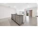 Kitchen island with granite countertop and gray cabinets at 1213 Red Hill Rd, Davenport, FL 33837