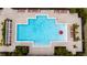 Community pool with lounge chairs and umbrella at 1213 Red Hill Rd, Davenport, FL 33837