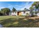 Ranch style home with gray exterior, wood accents, and manicured lawn at 130 N Fairfax Ave, Winter Springs, FL 32708