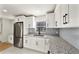 Modern kitchen with stainless steel appliances and gray tile backsplash at 130 N Fairfax Ave, Winter Springs, FL 32708