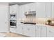 White kitchen cabinets, stainless steel appliances, and a quartz countertop at 13672 Fresh Ivy St, Winter Garden, FL 34787
