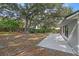 Large backyard with mature trees and a patio at 1395 Kenneth Ave, Casselberry, FL 32707