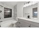 Updated bathroom with gray vanity, marble tile, and modern fixtures at 1395 Kenneth Ave, Casselberry, FL 32707