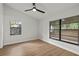 Bright bedroom with large windows, hardwood floors, and ceiling fan at 1395 Kenneth Ave, Casselberry, FL 32707