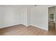 Bedroom with hardwood floors, double closet, and access to a hallway at 1395 Kenneth Ave, Casselberry, FL 32707