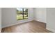 Well-lit bedroom with large window and hardwood floors at 1395 Kenneth Ave, Casselberry, FL 32707