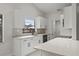 Modern white kitchen features quartz countertops, stainless steel appliances, and ample cabinet space at 1395 Kenneth Ave, Casselberry, FL 32707