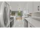 Bright kitchen with white shaker cabinets, quartz countertops, and stainless steel appliances at 1395 Kenneth Ave, Casselberry, FL 32707