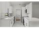 Renovated kitchen offers white cabinets, quartz countertops, and stainless steel appliances at 1395 Kenneth Ave, Casselberry, FL 32707