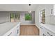Modern kitchen features white cabinets, quartz countertops, and an island at 1395 Kenneth Ave, Casselberry, FL 32707