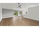 Open living area with wood-look flooring, sliding glass doors, and a ceiling fan at 1395 Kenneth Ave, Casselberry, FL 32707