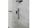 Modern shower with black fixtures and marble-look tile at 1395 Kenneth Ave, Casselberry, FL 32707